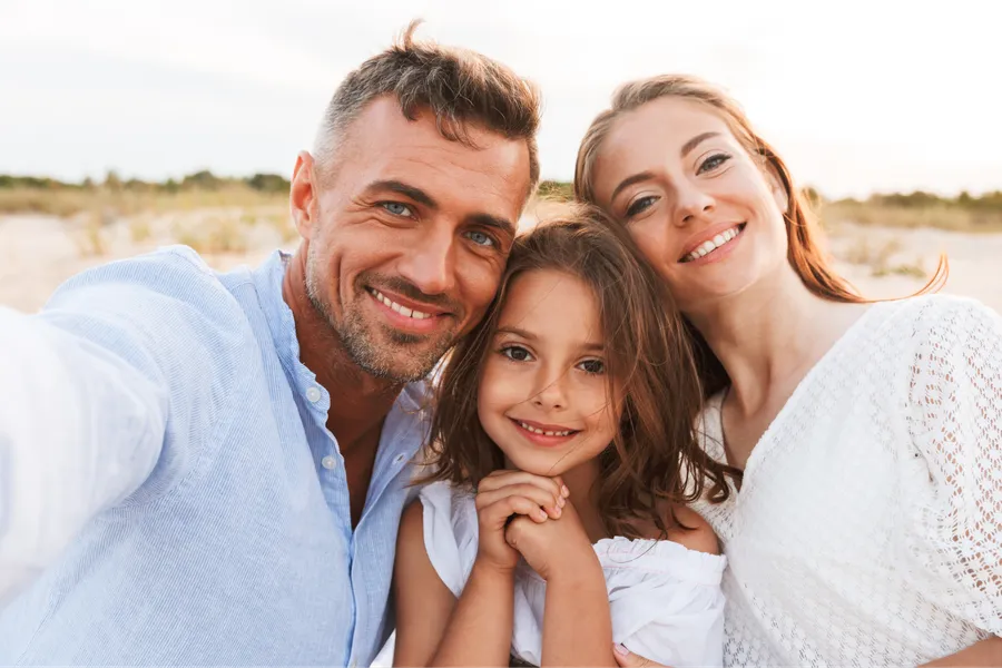 Family smiling together outdoors